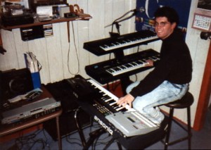 Me at my keyboard rig around 1990. "Time Takes Over" features sounds from the Roland U-20 synth on the top tier of my Apex stand (over the Ensoniq ESQ-1 on which I have my right hand).